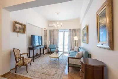 a living room with a couch and a tv at Sun-Kissed Koukaki Apartment City Views in Athens