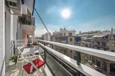 a balcony with a table and a chair at Sun-Kissed Koukaki Apartment City Views in Athens
