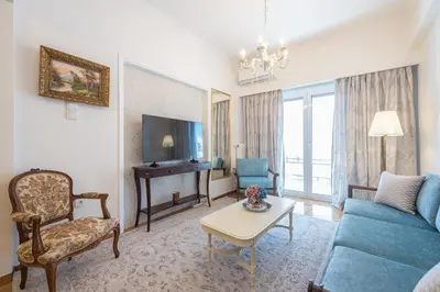 a living room with a blue couch and a tv at Sun-Kissed Koukaki Apartment City Views in Athens