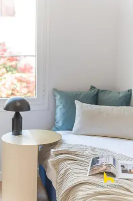 a bedroom with a bed and a table with a book on it at Spacious 3BR Retreat w 2 Baths & Fast Wi-Fi in Athens