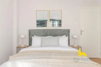 a bedroom with a large bed with two lamps at Spacious 3BR Retreat w 2 Baths & Fast Wi-Fi in Athens