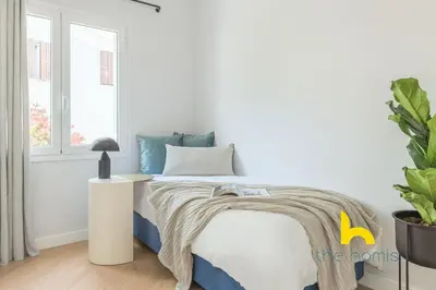 a white bedroom with a bed and a window at Spacious 3BR Retreat w 2 Baths & Fast Wi-Fi in Athens