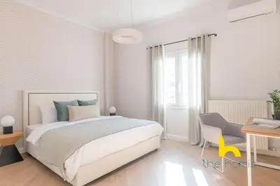 a white bedroom with a bed and a desk at Spacious 3BR Retreat w 2 Baths & Fast Wi-Fi in Athens