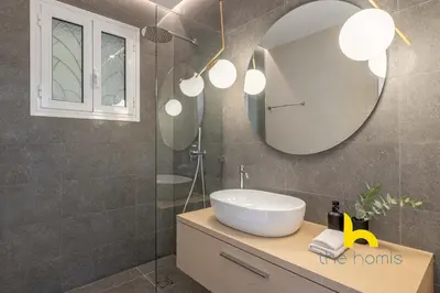 a bathroom with a sink and a mirror at Spacious 3BR Retreat w 2 Baths & Fast Wi-Fi in Athens