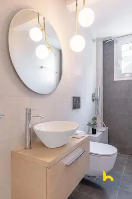 a bathroom with a sink and a mirror at Spacious 3BR Retreat w 2 Baths & Fast Wi-Fi in Athens