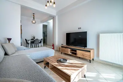 a living room with a couch and a tv at Central Nea Smyrni 2BR Apt-Near Transport by ΜΡS in Athens