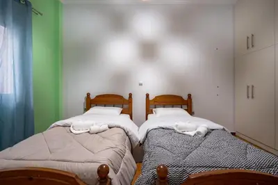 two twin beds in a room with green walls at Central Nea Smyrni 2BR Apt-Near Transport by ΜΡS in Athens