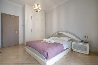 a bedroom with a bed with two towels on it at Central Nea Smyrni 2BR Apt-Near Transport by ΜΡS in Athens