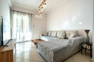 a living room with a couch and a tv at Central Nea Smyrni 2BR Apt-Near Transport by ΜΡS in Athens