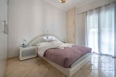 a white bedroom with a bed and a tv at Central Nea Smyrni 2BR Apt-Near Transport by ΜΡS in Athens