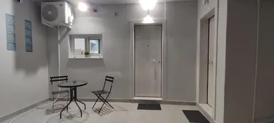 a dining area with a table and chairs in a room at Dream House Egaleo in Athens