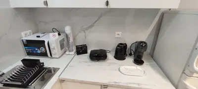 a kitchen with a white counter top with a microwave at Dream House Egaleo in Athens
