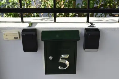 a green trash can with the number six on a wall at Dream House Egaleo in Athens