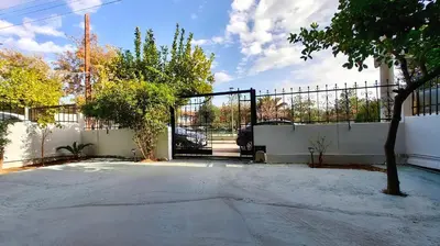 a gate to a driveway with a fence at Dream House Egaleo in Athens