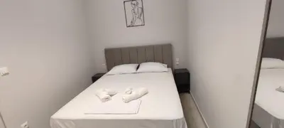 a bed with two towels on it in a room at Dream House Egaleo in Athens