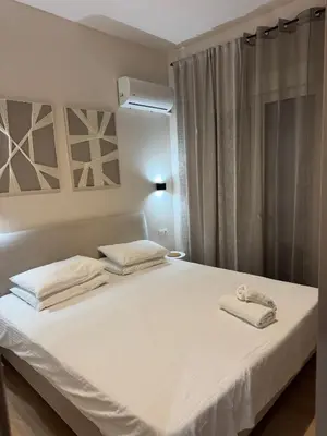 a bedroom with a white bed with towels on it at home 4 in Athens