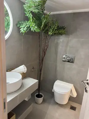 a bathroom with a toilet and a tree in it at home 4 in Athens