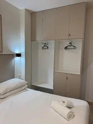 a bedroom with a bed with two towels on it at home 4 in Athens