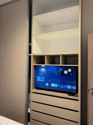a flat screen tv in a closet with a tv at home 4 in Athens