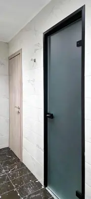 a glass door in a room with a wall at Kalisti House2Heal Athens in Athens