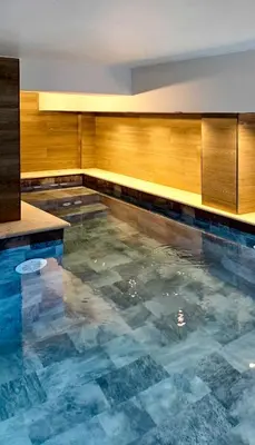 a pool of water in a room with wooden at Kalisti House2Heal Athens in Athens