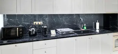 a kitchen counter with a microwave and a sink at Kalisti House2Heal Athens in Athens