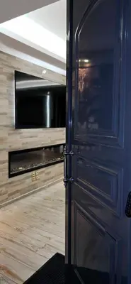a door leading into a room with a television at Kalisti House2Heal Athens in Athens