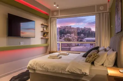 a bedroom with a bed with a large window at Acropolis View Dream Stay nr 5 in Athens