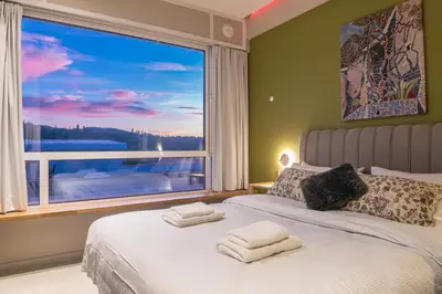 a bedroom with a bed with a large window at Acropolis View Dream Stay nr 5 in Athens
