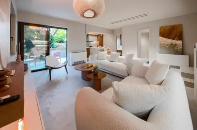 a living room with white couches and a table at Modern Αpartment 12 in the center of Glyfada in Athens