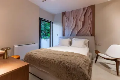 a bedroom with a large bed and a window at Modern Αpartment 12 in the center of Glyfada in Athens