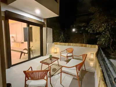 a patio with two chairs and a table on a balcony at Modern Αpartment 12 in the center of Glyfada in Athens