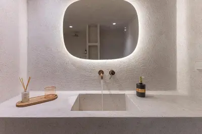 a bathroom with a sink with a round mirror at Modern Αpartment 12 in the center of Glyfada in Athens