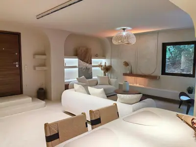 a living room with a couch and a table at Modern Αpartment 12 in the center of Glyfada in Athens