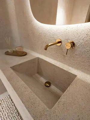 a sink with a gold faucet in a bathroom at Modern Αpartment 12 in the center of Glyfada in Athens