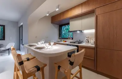 a kitchen with a table and chairs in a room at Modern Αpartment 12 in the center of Glyfada in Athens