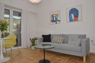 a living room with a couch and a table at Flat White in Athens
