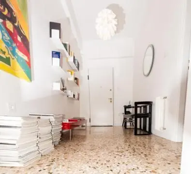 a room with a hallway with white walls and a floor at Flat White in Athens