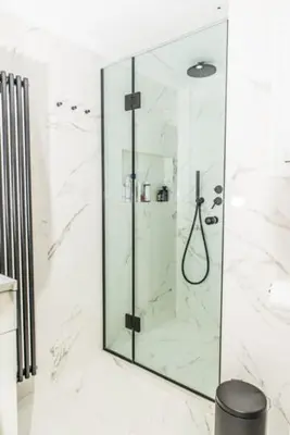 a bathroom with a shower with a glass at Flat White in Athens