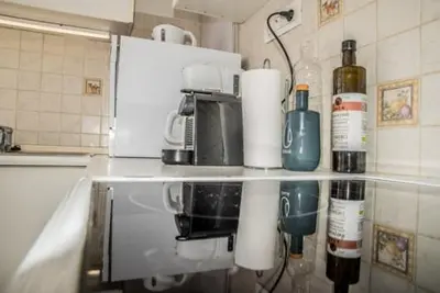 a kitchen with a counter with bottles of wine at Flat White in Athens