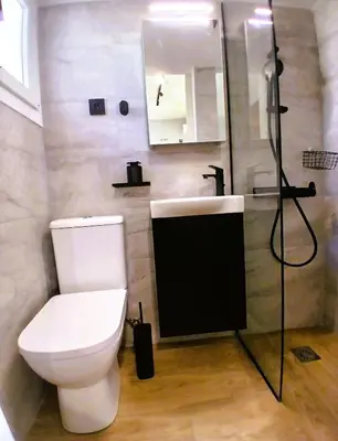 a bathroom with a toilet and a shower and a sink at Sky Garden, penthouse in Athens in Athens