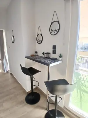 a room with a counter and two stools and a table at Sky Garden, penthouse in Athens in Athens
