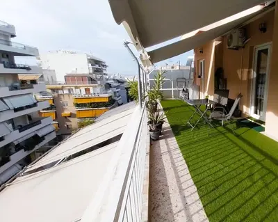 a balcony with green grass on a building at Sky Garden, penthouse in Athens in Athens