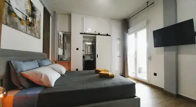 a bedroom with a bed and a television in it at Sky Garden, penthouse in Athens in Athens