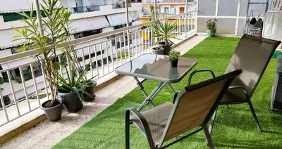 a balcony with a table and chairs and plants at Sky Garden, penthouse in Athens in Athens