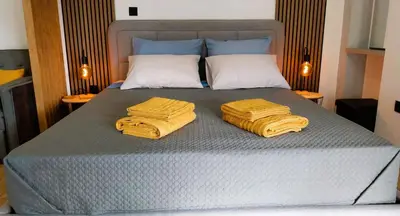 a bed with two yellow towels on top of it at Sky Garden, penthouse in Athens in Athens