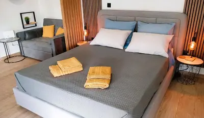 a large bed with two towels on top of it at Sky Garden, penthouse in Athens in Athens
