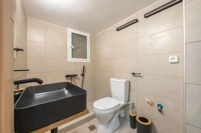a bathroom with a sink and a toilet at Athenian home near Acropolis in Athens