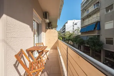 a balcony with two chairs and a table on it at Athenian home near Acropolis in Athens