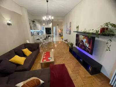 a living room with a couch and a tv at Minimal Central 2BR in Athens